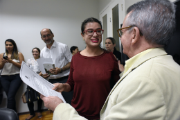 Imagem: Carla Roberta Macedo de Sousa, servidora que vai para o Campus de Sobral, recebe o termo de posse do Prof. Henry Campos (Foto: Jr. Panela)